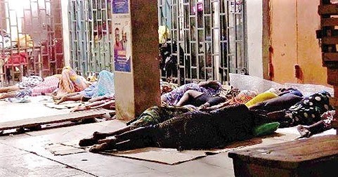 Some Kayayei sleeping in front of a shop at Darkuman in Accra