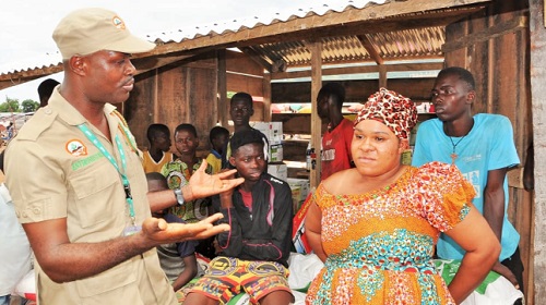 Mr Lomotey interacting with a pesticide seller at the Tongor-Dzemeni Market