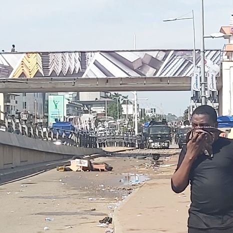 A man covering his nose after the police fired tear gas to disperse the crowd 