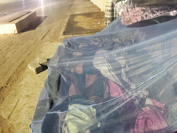  The two children covered with cloth and an old mosquito net while sleeping