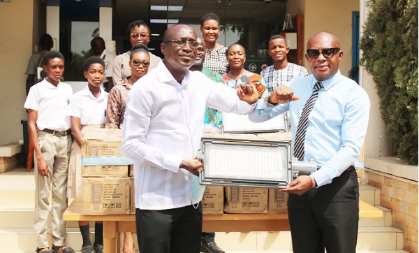 Kofi Agyarko (left) presenting the lights to Rev. Mordeceai Nickson Nubour of ATTC, while some students and staff of both the commission and school look on. Picture: DELLA RUSSEL OCLOO Kofi Agyarko (left) presenting the lights to Rev. Mordeceai Nickson Nubour of ATTC, while some students and staff of both the commission and school look on. Picture: DELLA RUSSEL OCLOO