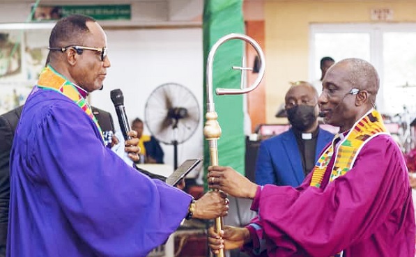 Bishop S. N. Mensah (left), outgoing President of the FGCI, handing over the staff of leadership to new President, Rt Rev. Godwin Dela Fiagome, at the induction ceremony Bishop S. N. Mensah (left), outgoing President of the FGCI, handing over the staff of leadership to new President, Rt Rev. Godwin Dela Fiagome, at the induction ceremony