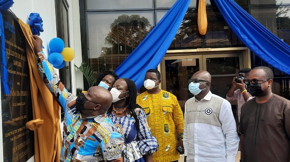  Joseph Cudjoe, Minister of Public Enterprises unveiling a plaque. Behind him are Professor Nana Aba Amfo, Vice Chancellor of the University of Ghana and Professor Peter Quartey (third right).