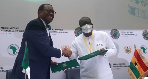 Ken Ofori-Atta (right), Minister of Finance, and Dr Akinwumi Adesina, President of the AfDB Group, exchanging copies of the agreement Ken Ofori-Atta (right), Minister of Finance, and Dr Akinwumi Adesina, President of the AfDB Group, exchanging copies of the agreement