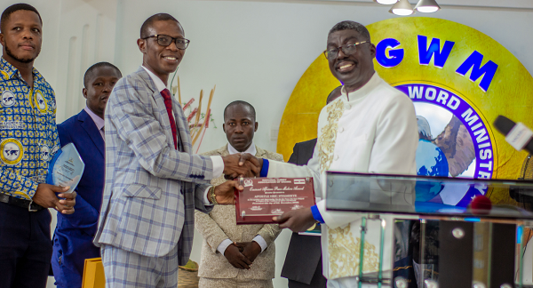 The Director of Postgraduate Studies & Research of the Pentecost University College, Apostle Dr. Christian Tsekpoe, picking an award on behalf of the Chairman of the Church of Pentecost, Apostle Dr Eric Nyamekye