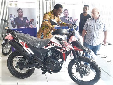 Mark Mehrlaender (right) handing over a motorbike to David Djangmah Tawiah, one of the beneficiaries Mark Mehrlaender (right) handing over a motorbike to David Djangmah Tawiah, one of the beneficiaries