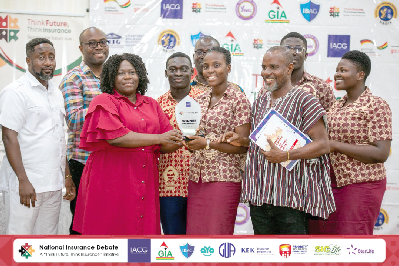 Nicholina Naa Yeye Adumuah (2nd from left), Central Regional Manager of NIC, presenting the award to the winners National Insurance Debate: Komenda College of Education books spot in finals