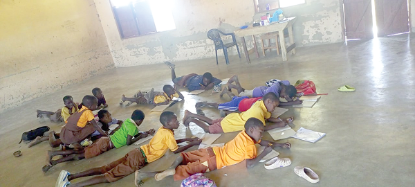 Primary three pupils of Beo Tankoo primary school lying on the floor to take part in a lesson Primary three pupils of Beo Tankoo primary school lying on the floor to take part in a lesson
