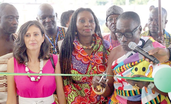 Nana Ampofoh Kyei-Baffour II (right), the Asemhene, cutting the tape to officially launch the 2022 GrEEn Fair in Kumasi. Looking on are Gloria Bortele Noi (middle), Director of Policy Planning Monitoring &amp; Evaluation, Ministry of Employment and Labour Relations, and Marta Brignone, Programme Manager of Green Project at the European Union in Ghana