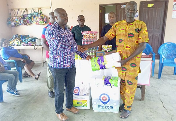Selorm Adzorze (left), the Volta Regional Chairman of UNICOF, presenting the items to Nelson Atito, the Manager of the Lepers village Selorm Adzorze (left), the Volta Regional Chairman of UNICOF, presenting the items to Nelson Atito, the Manager of the Lepers village