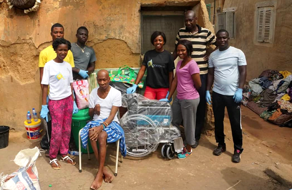 Roberta Adutwumwaa attending to an elderly woman during one of her visits. INSET: The entire team of Good Old Age Golden Foundation with an elderly person after the presentation of a wheelchair