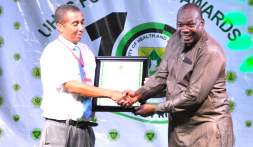 Prof. Seth Owusu-Agyei (right), former Pro-Vice Chancellor of UHAS, presenting the citation to Alberto Mario Noretti of the Daily Graphic