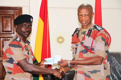 Chief Fire Officer Julius A. Kuunour presenting a cheque to one of the beneficiaries Chief Fire Officer Julius A. Kuunour presenting a cheque to one of the beneficiaries