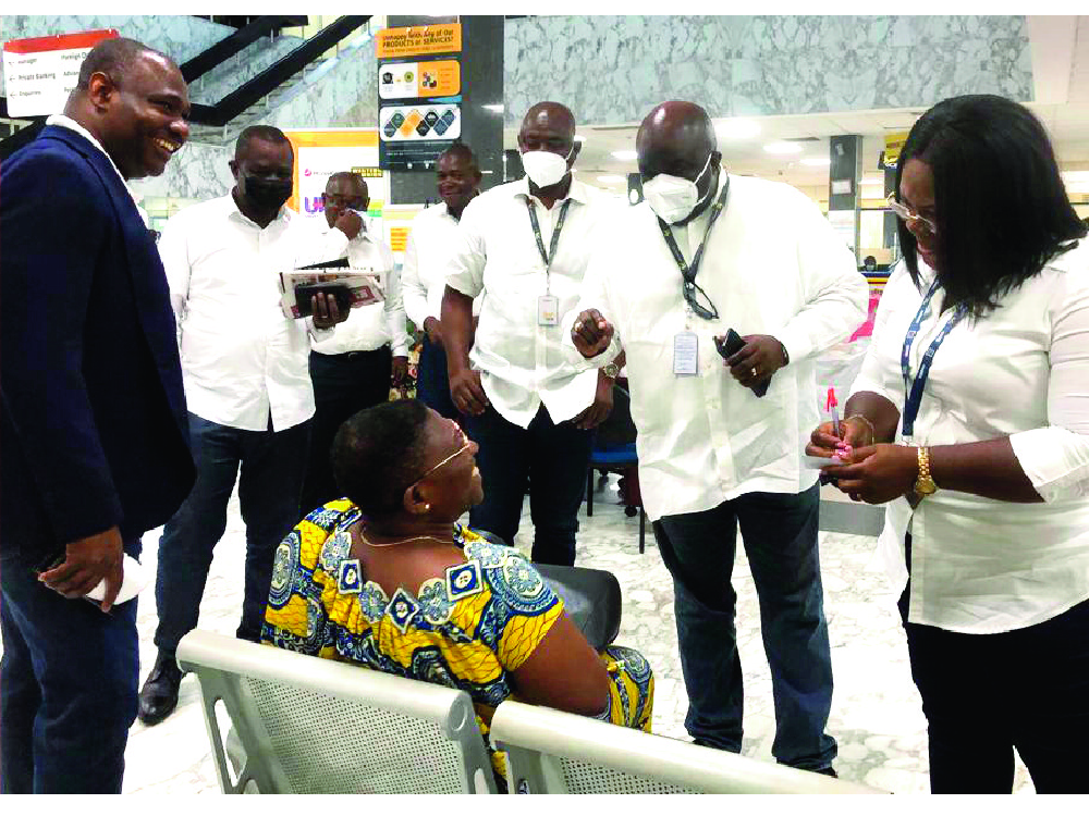 Kofi Adomakoh (arrowed), the MD of GCB Bank PLC, with some management staff interacting with a customer of the bank GCB Bank improves services to meet modern banking trends