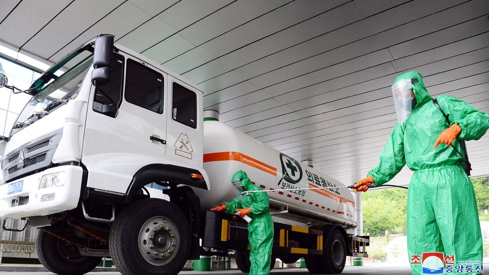 A worker disinfects a vehicle carrying medical oxygen, in Pyongyang North Korea fighting COVID-19 with tea and salt water