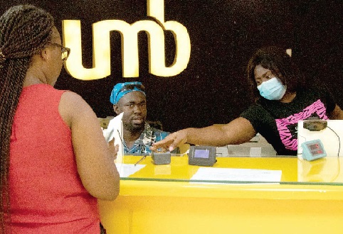 Staff of the bank attending to a customer (back to camera) Staff of the bank attending to a customer (back to camera)