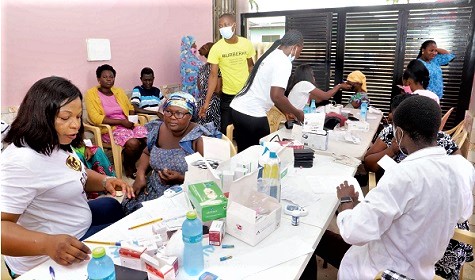  Dr Rosemond Aboagye (left) Medical Director of RAMD Medical Imaging taking the patients through the health screening exercise at Kasoa.