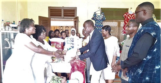 Very Rev. Emmanuel Evans Essien (4th from right), the Superintendent Minister of the New Aplaku Circuit, presenting the items to Rebecca Nettey, the Accra Diocesan Coordinator on Gender and Family Life Issues, while others look on Very Rev. Emmanuel Evans Essien (4th from right), the Superintendent Minister of the New Aplaku Circuit, presenting the items to Rebecca Nettey, the Accra Diocesan Coordinator on Gender and Family Life Issues, while others look on