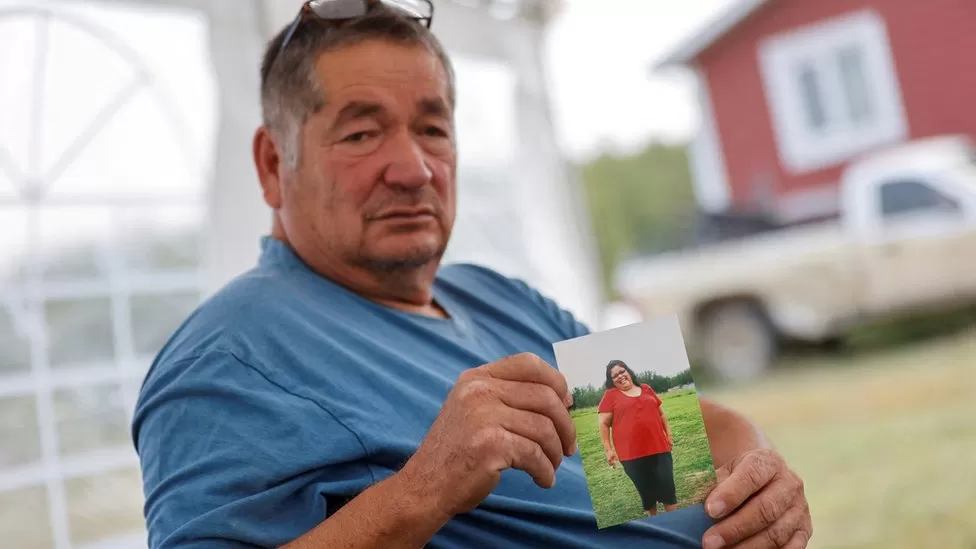 Darryl Burns holds a photo of his sister, Gloria, a former first responder Canada stabbings: Relatives identify 'random' victims of Saskatchewan attack