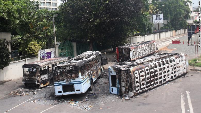 Burned buses near the official residence of Sri Lanka's outgoing Prime Minister, Mahinda Rajapaksa, in Colombo, a day after they were torched by protesters on May 10. Burned buses near the official residence of Sri Lanka's outgoing Prime Minister, Mahinda Rajapaksa, in Colombo, a day after they were torched by protesters on May 10.