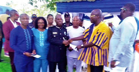 Richmond Amponsah Agyabeng (right), presenting the citation to DCOP Adikah. Also with them is Victoria Adu (2nd from left), the Birim Central DCE Richmond Amponsah Agyabeng (right), presenting the citation to DCOP Adikah. Also with them is Victoria Adu (2nd from left), the Birim Central DCE