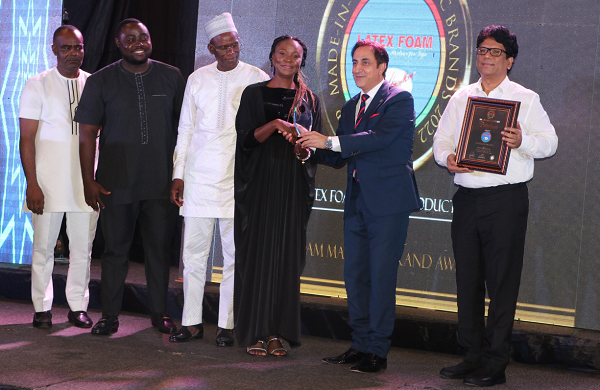 The Lebanese Ambassador to Ghana, H.E. Maher Kheir (2nd right) presenting a plaque to the Public Relations Officer of Latex Foam, Mrs Gifty E. Appiah. Holding the citation is the Head of Manufacturing, Saibabu Manchella. Supporting on the stage are other officials of Latex Foam, including the Export Manager, Dr Yakubu Diomande (3rd left). The Lebanese Ambassador to Ghana, H.E. Maher Kheir (2nd right) presenting a plaque to the Public Relations Officer of Latex Foam, Mrs Gifty E. Appiah. Holding the citation is the Head of Manufacturing, Saibabu Manchella. Supporting on the stage are other officials of Latex Foam, including the Export Manager, Dr Yakubu Diomande (3rd left).
