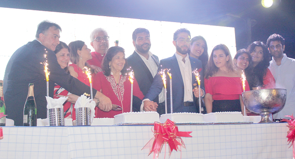 Owners and management of Melcom cutting a cake at the event to signify its new brand identity Owners and management of Melcom cutting a cake at the event to signify its new brand identity