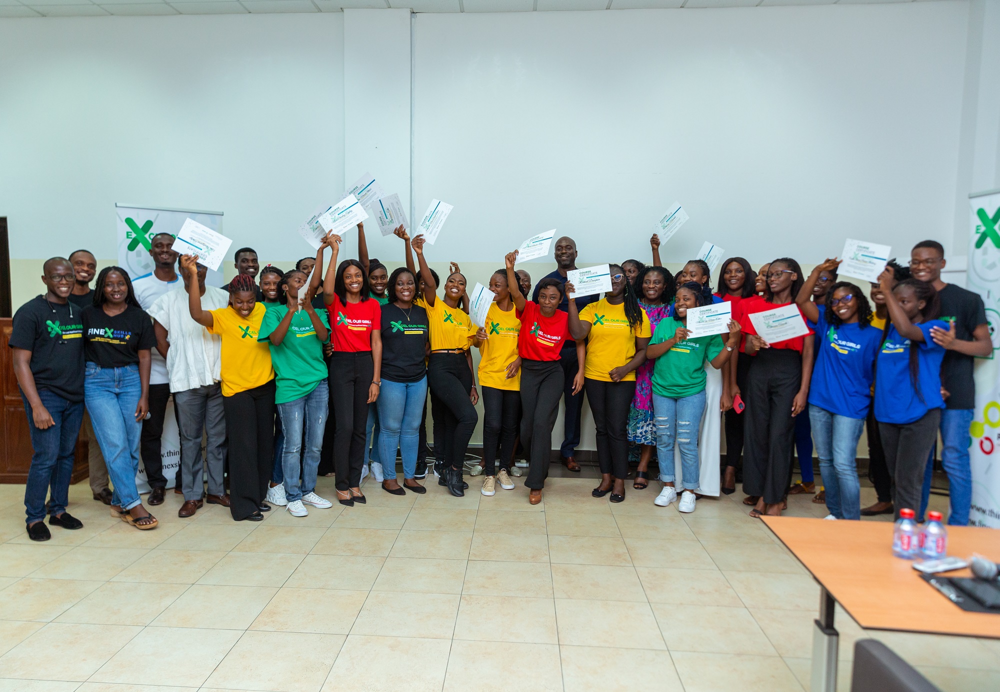 The graduates display their certificates Excel programme equips 22 girls with digital skills