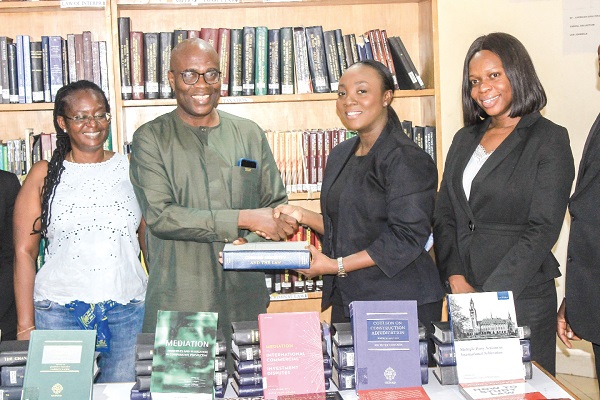Akua Addae Pinamang (2nd from right), Head of Secretary Department, Kimathi and Partners, donating the books to Joe Antah (2nd from left), Head of University of Ghana School of Law library, who is receiving it on behalf of Prof. Raymond Atuguba, Dean of the School of Law, University of Ghana. Picture: ERNEST KODZI Kimathi and Partners donates books to UG Law School