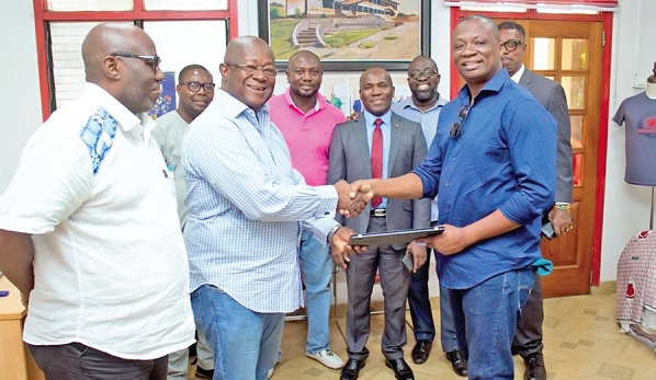 • Mohammed Baakoe (right), CEO of DRW, Canada, presenting one of the laptops to Captain Paul Forjoe, President of MOBA, while other members look on • Mohammed Baakoe (right), CEO of DRW, Canada, presenting one of the laptops to Captain Paul Forjoe, President of MOBA, while other members look on