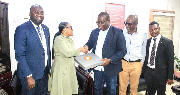 • Esi E. Mills-Robertson (2nd from left), Director, Inclusive Banking, presenting a gift to Theophilus Yartey, Editor, Graphic. With them are Eric Frempong Amponsah (left), Head of Marketing, Fidelity Bank, Maurice Quansah, Editor, Graphic Sports, and a member of staff of Fidelity Bank. Picture: ERNEST KODZI • Esi E. Mills-Robertson (2nd from left), Director, Inclusive Banking, presenting a gift to Theophilus Yartey, Editor, Graphic. With them are Eric Frempong Amponsah (left), Head of Marketing, Fidelity Bank, Maurice Quansah, Editor, Graphic Sports, and a member of staff of Fidelity Bank. Picture: ERNEST KODZI