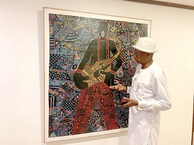 Edward Lamptey, a Creative Art Director at the Edrose Gallery, explaining the concept behind one of his works Edward Lamptey, a Creative Art Director at the Edrose Gallery, explaining the concept behind one of his works