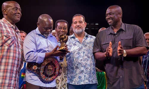 Boxing icon Azumah Nelson, flanked by officials of GBA and Imax Promotions, admiring the bronze glove presented to him Azuman and GBA officials