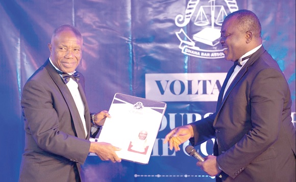 Jones Victor Mawulorm Dotse (left) receiving a citation from Nelson Mawutor Kporha