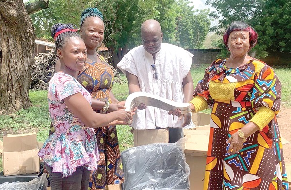 Vida Anaab (right), Builsa North MCE, presenting an equipment to one of the beneficiaries Vida Anaab (right), Builsa North MCE, presenting an equipment to one of the beneficiaries