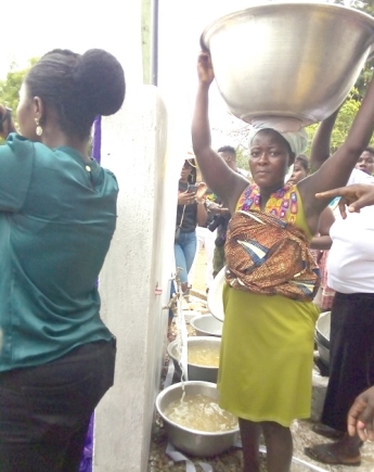 A community member fetching water after the inauguration
