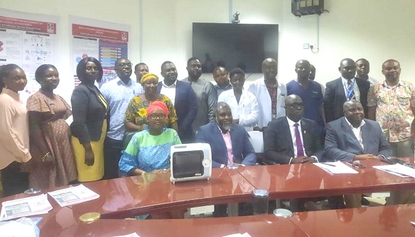 The researchers with the management of KATH during the presentation. On the table is one of the ventilators The researchers with the management of KATH during the presentation. On the table is one of the ventilators