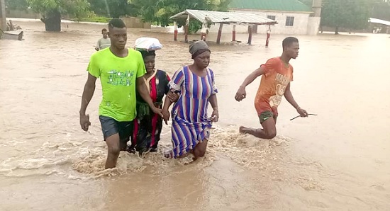 Some residents wading through the flood caused by the downpour Some residents wading through the flood caused by the downpour