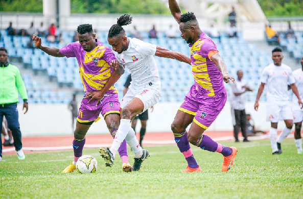 Isaac James of Remo Stars is sandwiched between Medeama SC skipper, Vincent Atinga (right) and Godknows Dzakpasu Isaac James of Remo Stars is sandwiched between Medeama SC skipper, Vincent Atinga (right) and Godknows Dzakpasu