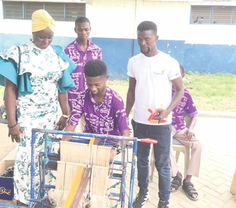 Ms Mahei looking on as a man with special needs weaves a cloth as part of an inclusive technical education programme Ms Mahei looking on as a man with special needs weaves a cloth as part of an inclusive technical education programme
