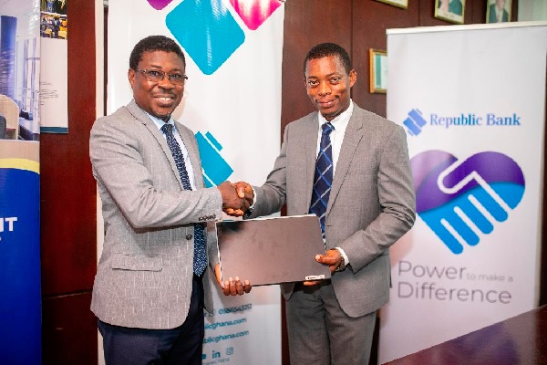 • Prof. Justice Nyigmah Bawole (left), Dean of UGBS, receiving one of the laptops from Joseph Laryea Ashong, General Manager, Commercial and Retail Banking Republic Bank (Ghana) PLC supports 2 institutions