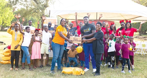 Majorie Quansah presenting a gift to one of the children Majorie Quansah presenting a gift to one of the children