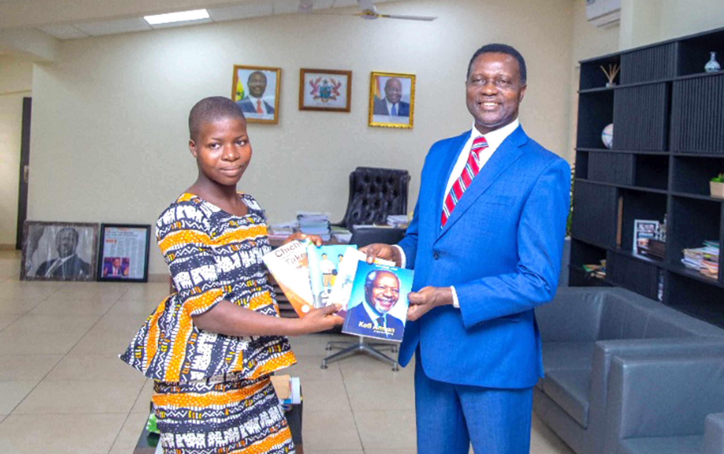 Dr Yaw Osei Adutwum, Minister of Education, presenting some books to Doris Ahiable. Class 6 pupil meets Education Minister