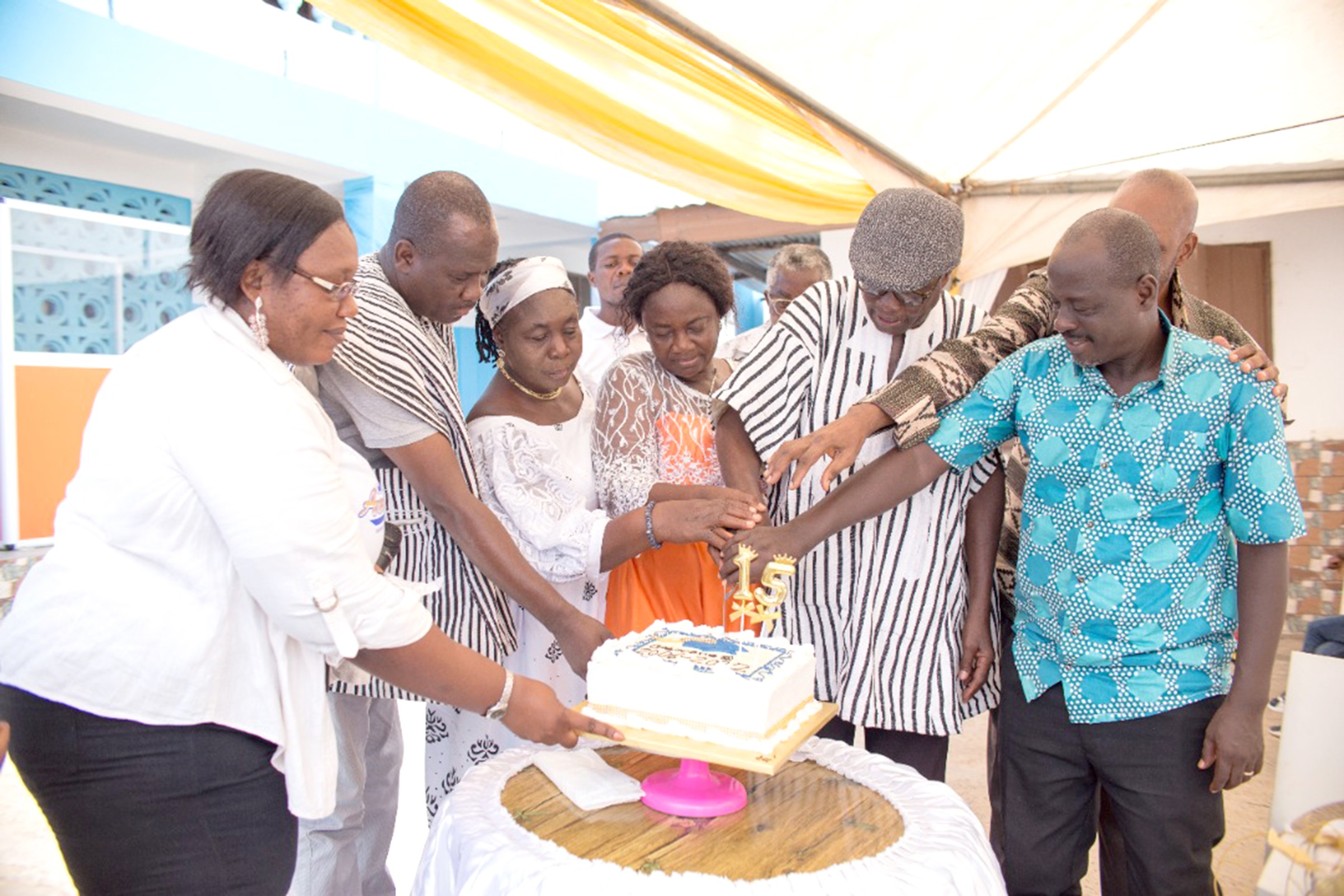 Mr Francis Kwaku Nyarko (arrowed), the Headmaster of the school, cutting the anniversary cake with invited guests.. Gaborone West International School celebrates 15th anniversary