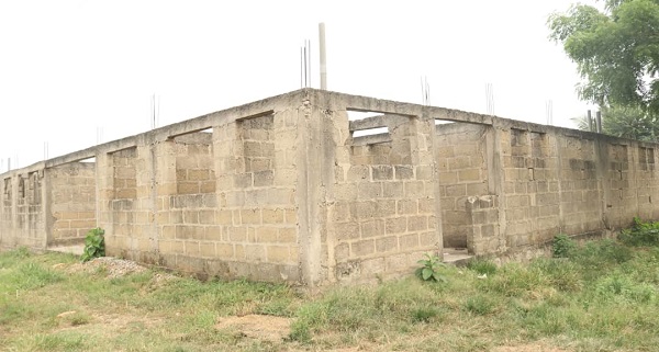 • The under-construction new maternity ward which has stalled at the lintel level. INSET: Dr Emmanuel Acquaah-Harrison (right) briefing Alexander Akwasi Acquah (left), the MP, about the situation at the Oda Government Hospital Oda Govt Hospital cries for help