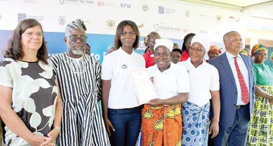 Madam Babalimbi Turzuah, Chairperson of LEWSA, showing off her certificate after receiving it from the GIZ officials Madam Babalimbi Turzuah, Chairperson of LEWSA, showing off her certificate after receiving it from the GIZ officials
