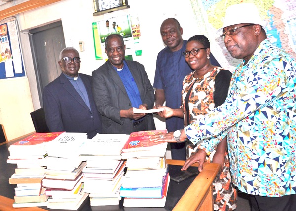 Rev. Dr Setri Nyomi (2nd from left) presenting the books to Dr Amy Asimah while others look on Rev. Dr Setri Nyomi (2nd from left) presenting the books to Dr Amy Asimah while others look on