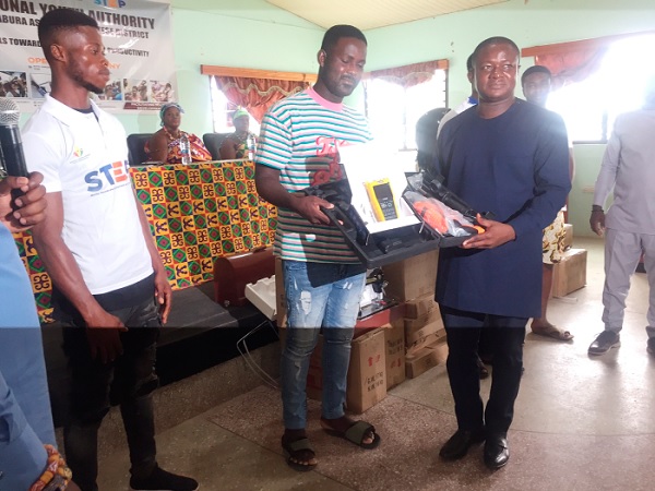 • Elvis Donkoh (right), MP for Abura-Asebu-Kwamankese, presenting apprenticeship tools to a beneficiary 20 Receive support for vocational training
