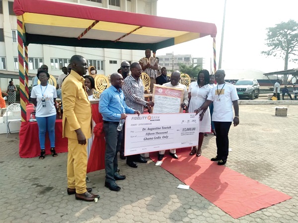 Nana Effah Apenteng (3rd from right), Board Chairman of KATH, presenting the citation of the Overall Best Staff to a colleague of Dr Augustine Tawiah. Make patients your priority — KATH CEO