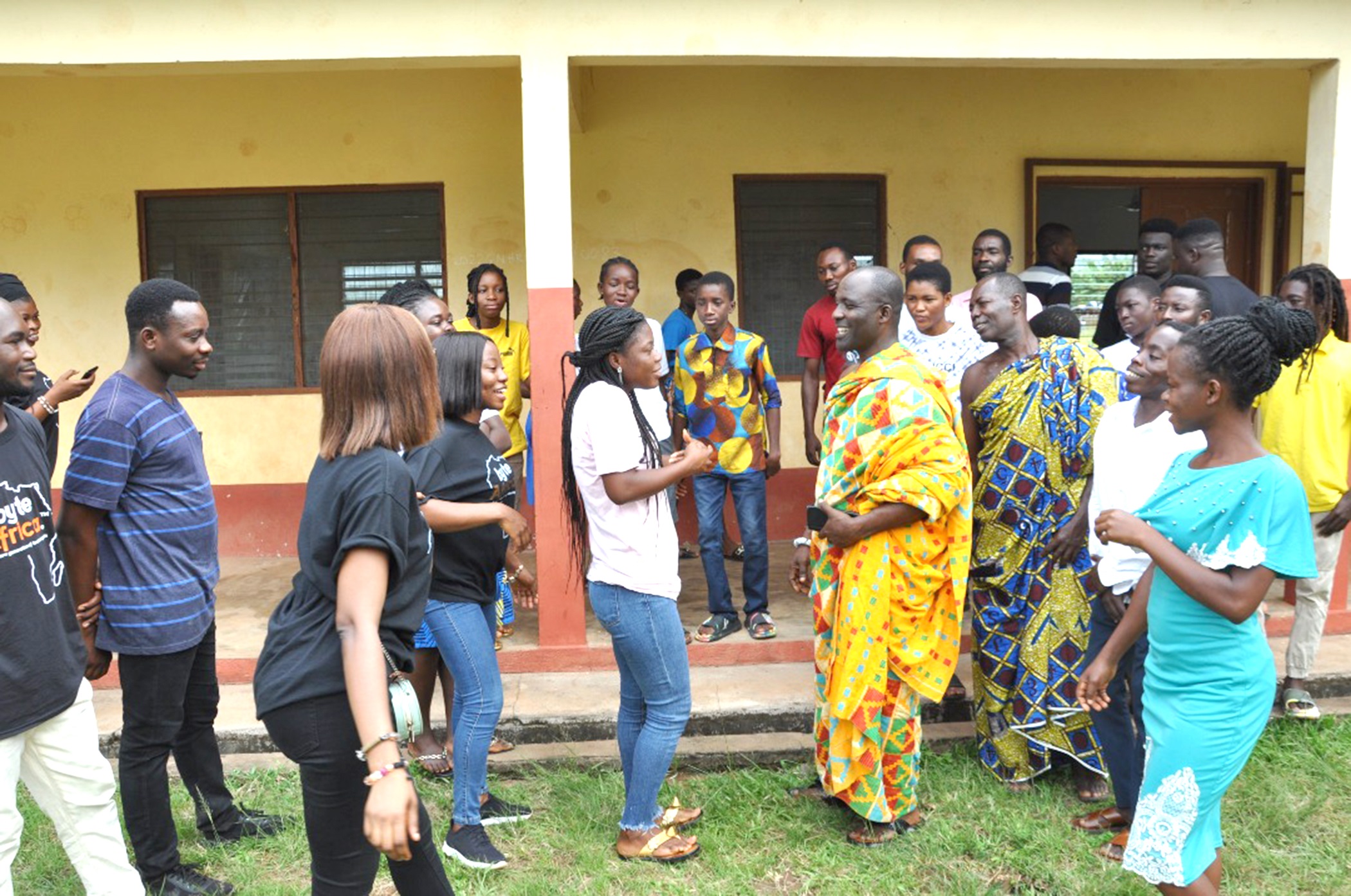 Togbe Dzaga XI, Paramount Chief of Klefe (in kente) interacting with some of the participants. Klefe children sensitised to use of technology